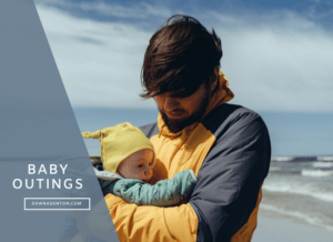 a father with his baby on the beach
