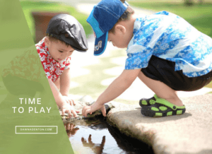 boys playing outside in a stream